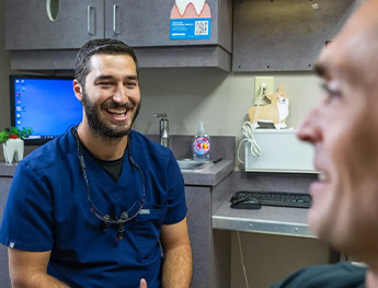 team member showing implant model to patient in Worcester